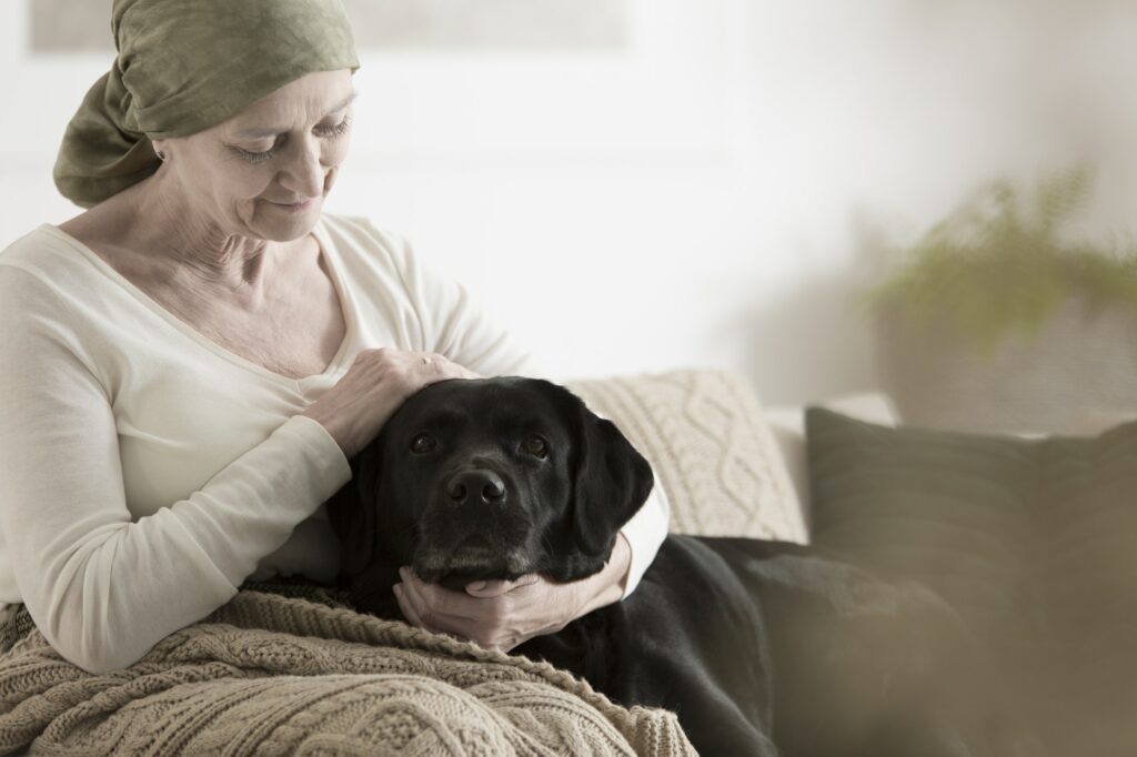 Grandmother with headscarf stroking dog