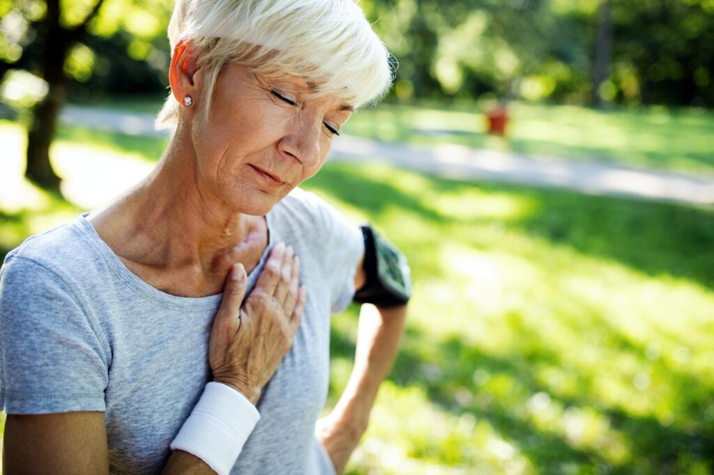 Mature woman exercising outdoors to prevent cardiovascular diseases and heart attack